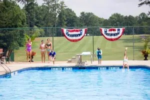 children diving into the pool